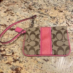 pink/tan patterned coach wristlet